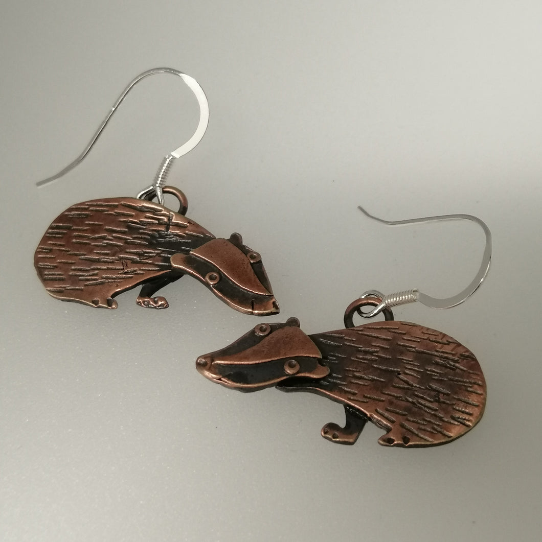 Badger earrings in a copper finish with silver hooks handmade by Sharon McSwiney