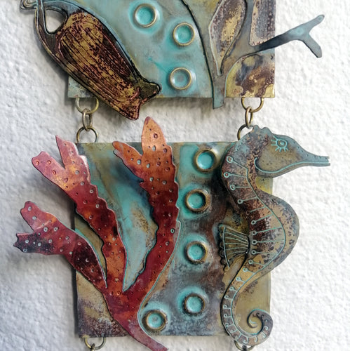 Metalwork wall panel with 3 sections featuring seaweed, a seahorse & mermaids purse handmade by Sharon McSwiney