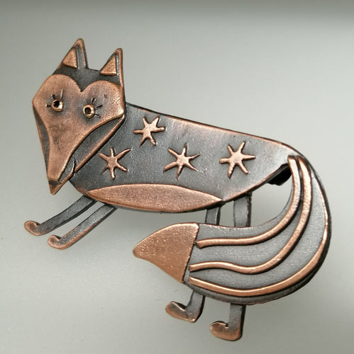 Fox brooch with stars on its body in a copper finish handmade by Sharon McSwiney