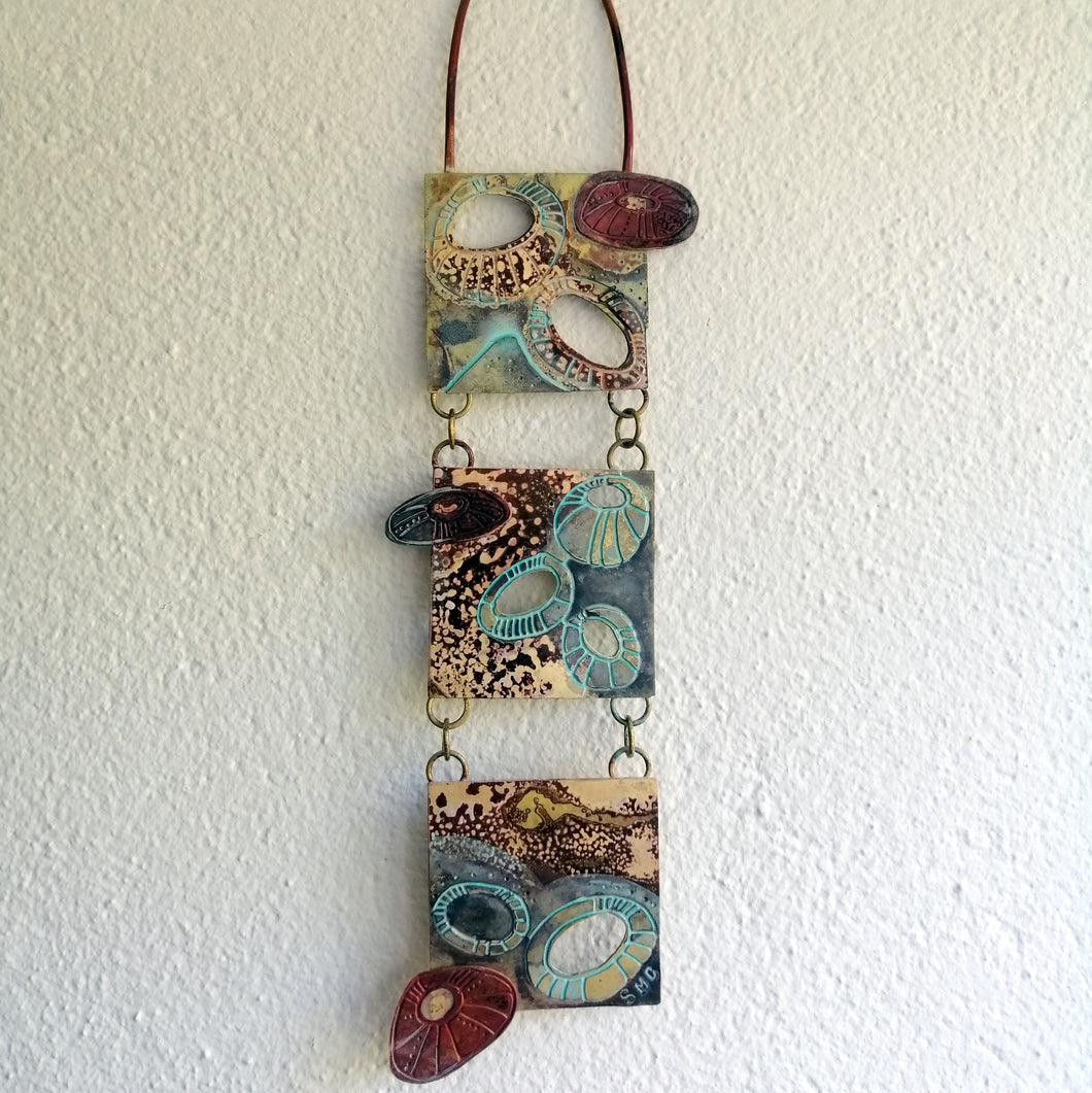 Mini metalwork wall panel with etched limpet designs by Sharon McSwiney