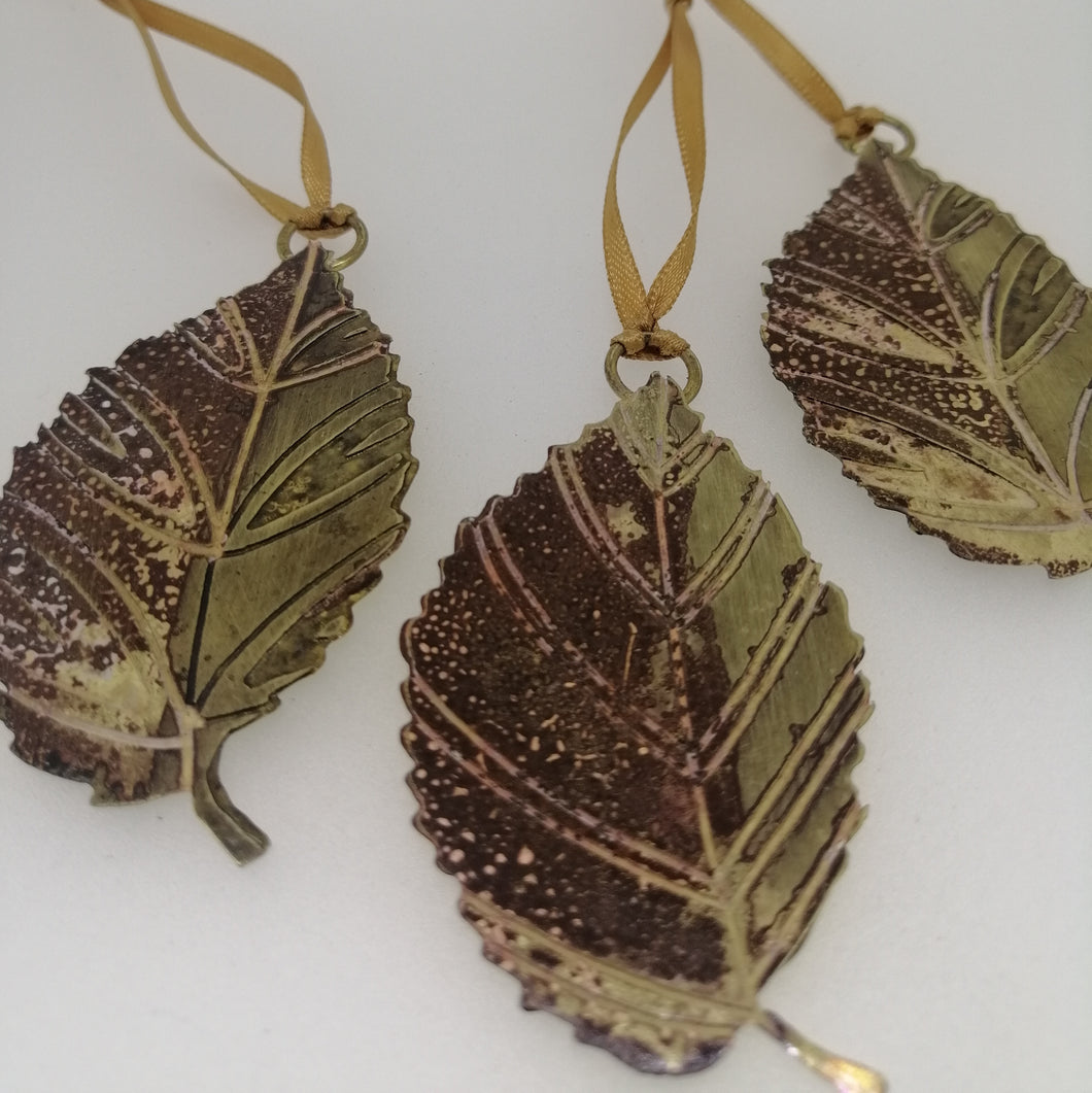 Small brass beech leaf decorations handmade by Sharon McSwiney
