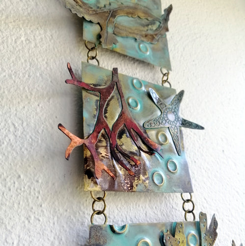 Metalwork wall panel with 3 sections featuring seaweed, a sea anemone & starfish handmade by Sharon McSwiney