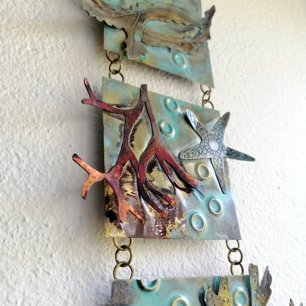 Metalwork wall panel with 3 sections featuring seaweed, a sea anemone & starfish handmade by Sharon McSwiney
